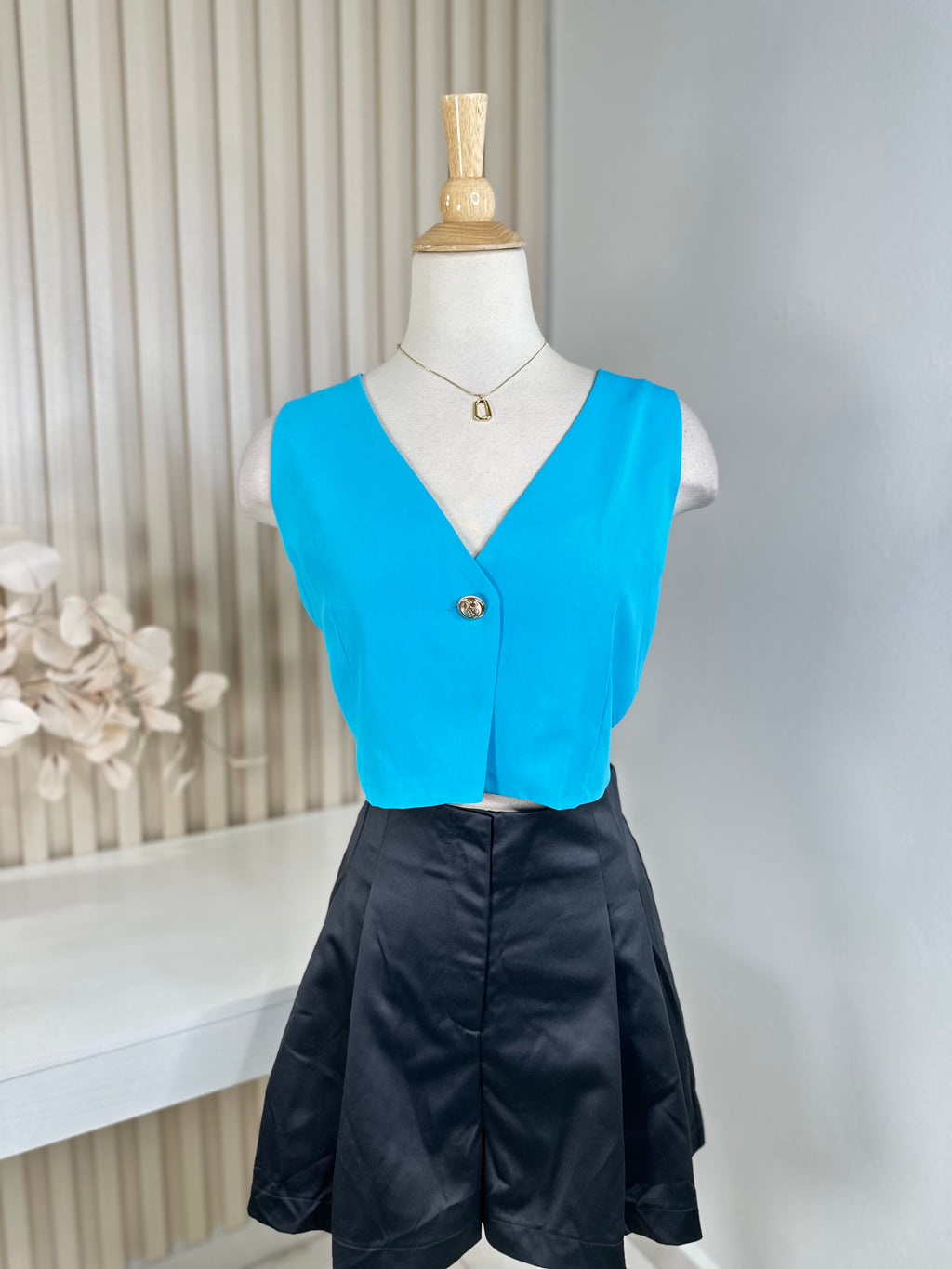 Light blue vest gold button